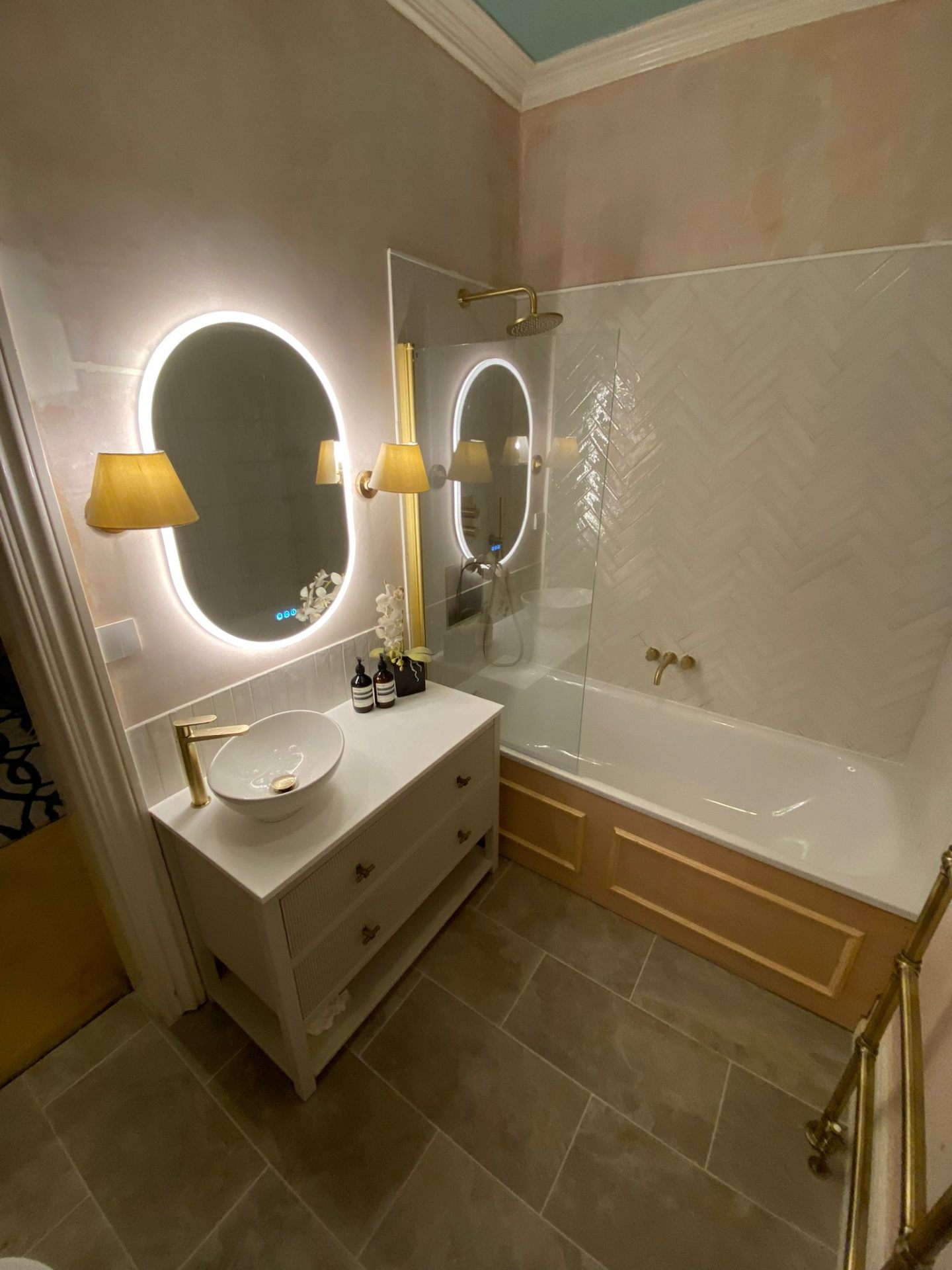 Modern freestanding bath installation with herringbone tiles by LUXE Bathrooms in Uckfield, East Sussex
